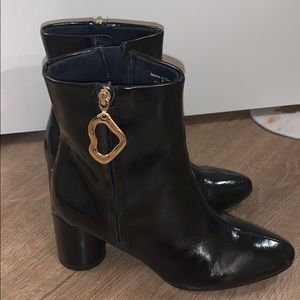 Black booties with gold shaped zipper